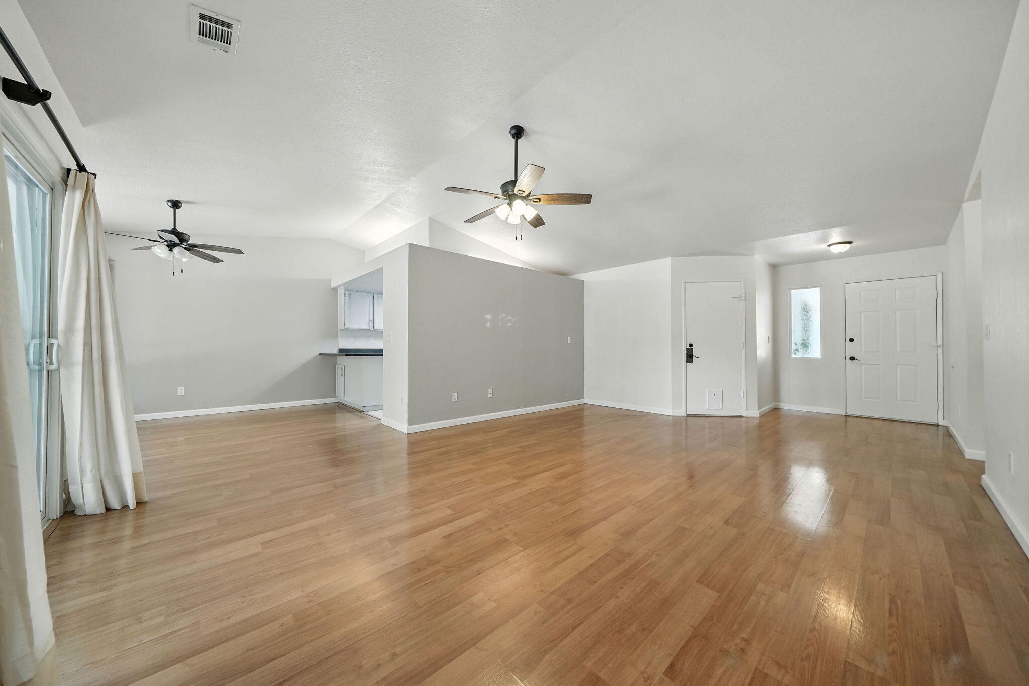 3588 Magnums Way Redding, CA 96003 - Photo 6 of 35 a view of a livingroom with a ceiling fan window and wooden floor