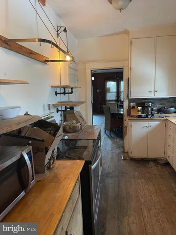 a kitchen with a stove a sink and a refrigerator