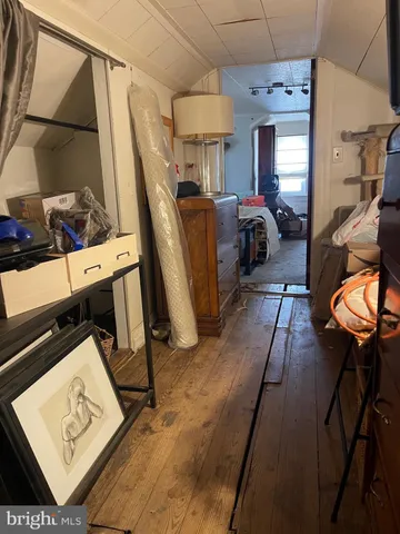 a view of living room with furniture and a mirror