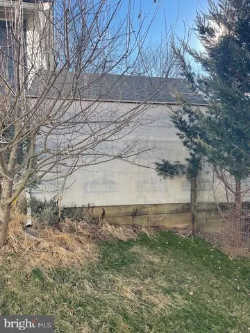 a view of a yard with large trees