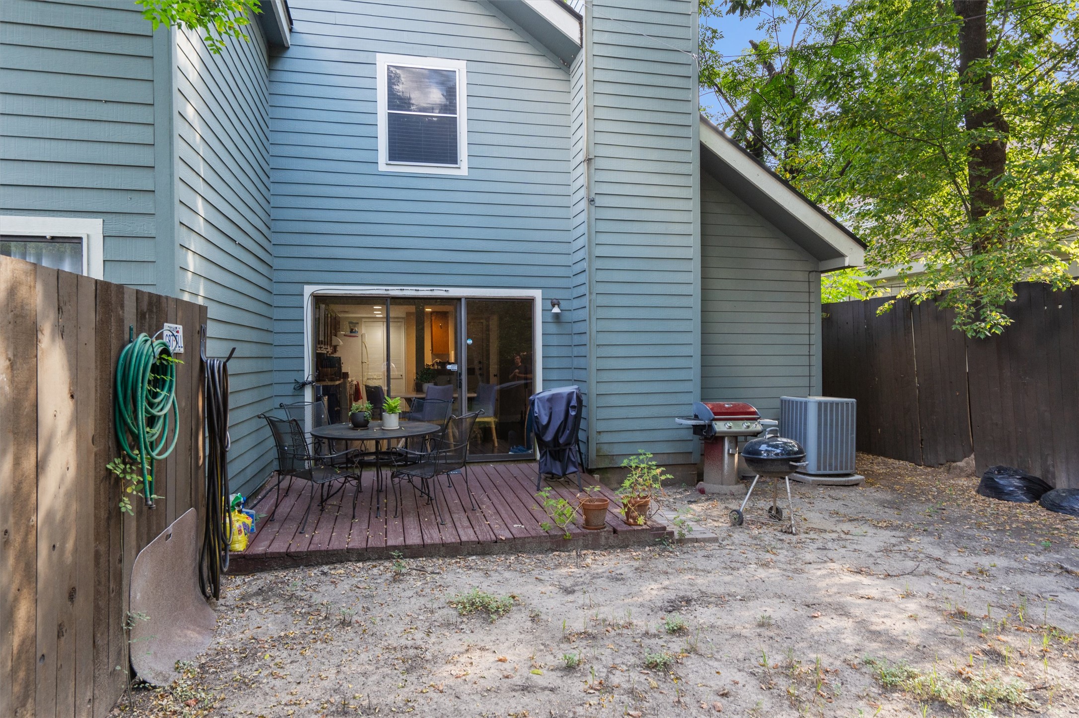 2414 Jones Road Austin, TX 78745 - Photo 24 of 26 A spacious backyard provides a private outdoor retreat with a wooden deck and ample room for recreation.