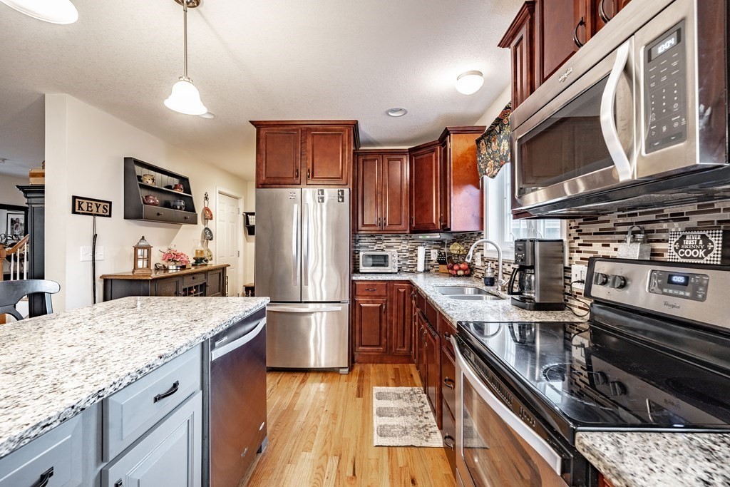 79 Judson Street Springfield, MA 01104 - Photo 16 of 38 a kitchen with stainless steel appliances granite countertop a stove refrigerator sink and microwave