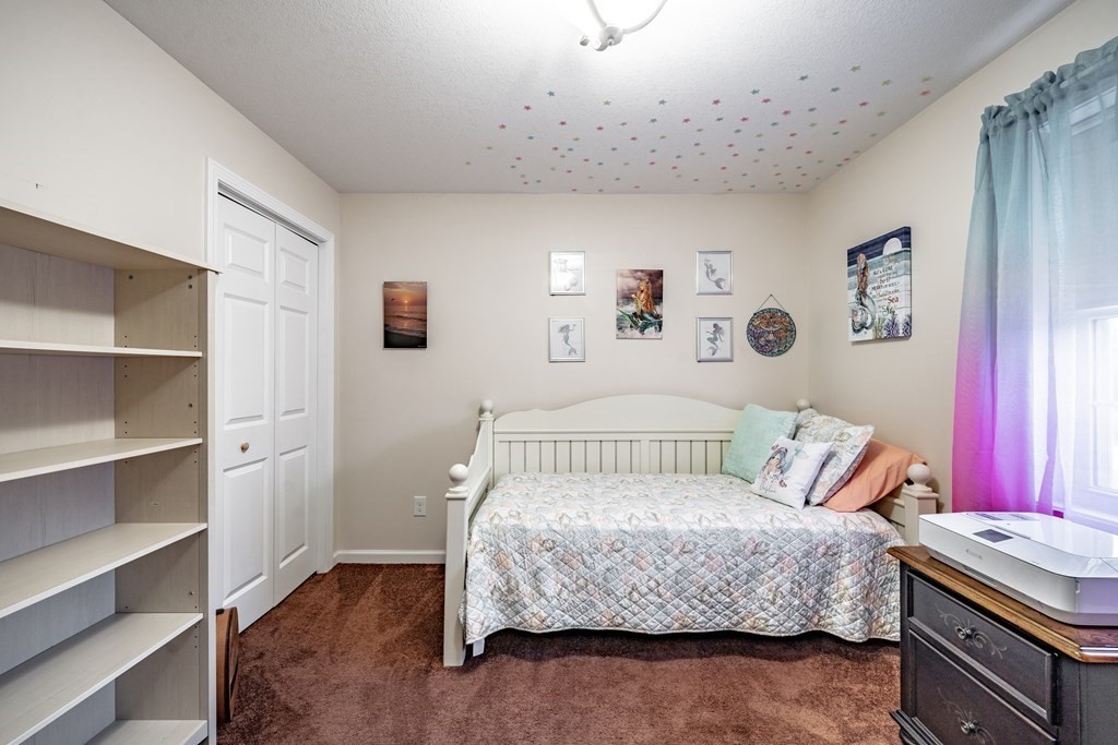79 Judson Street Springfield, MA 01104 - Photo 24 of 38 a bedroom with a bed and paintings on the wall
