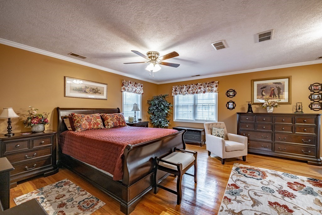 79 Judson Street Springfield, MA 01104 - Photo 31 of 38 a bedroom with a bed and dresser with wooden floor