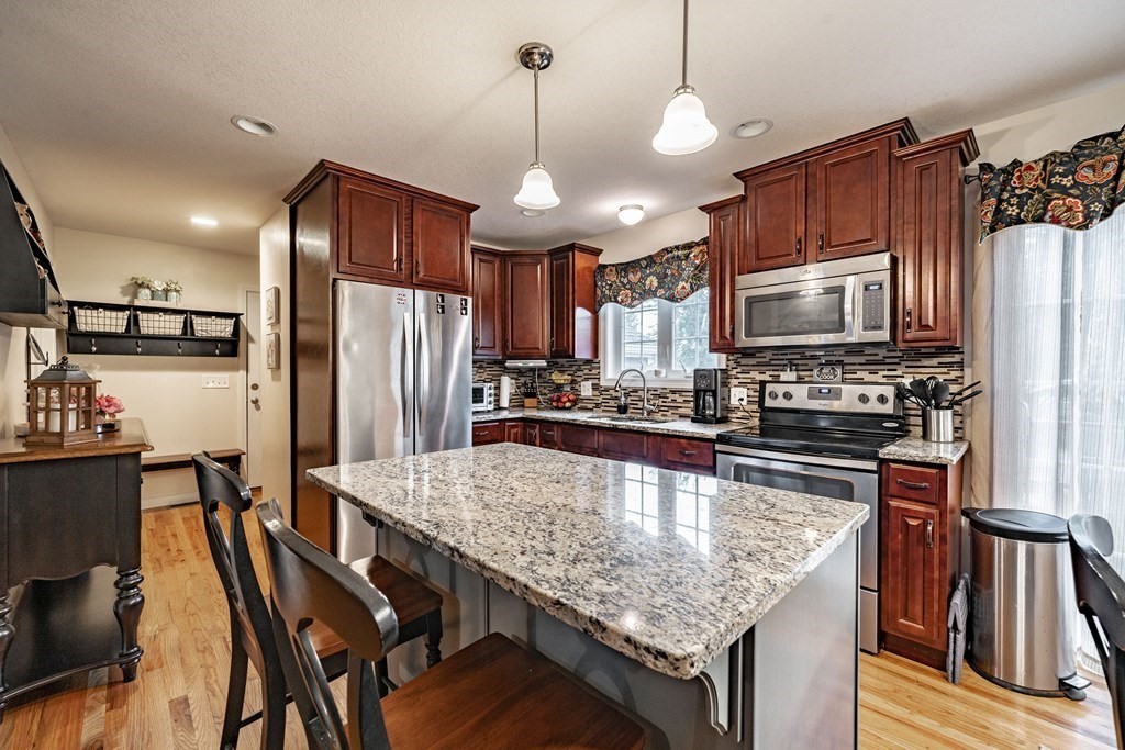 79 Judson Street Springfield, MA 01104 - Photo 10 of 38 a kitchen with granite countertop a table chairs stainless steel appliances and cabinets
