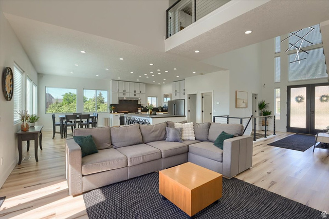 828 South Deer Road Tooele, UT 84074 - Photo 14 of 51 Open-concept living area with light wood-finish flooring, high ceilings, and recessed lighting