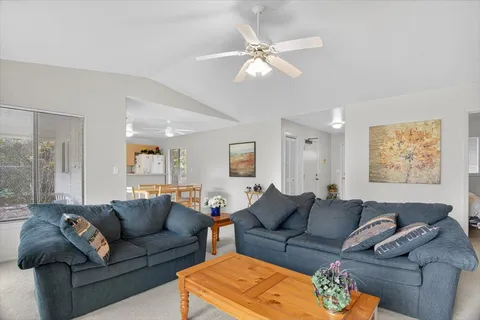 a living room with furniture and a large mirror