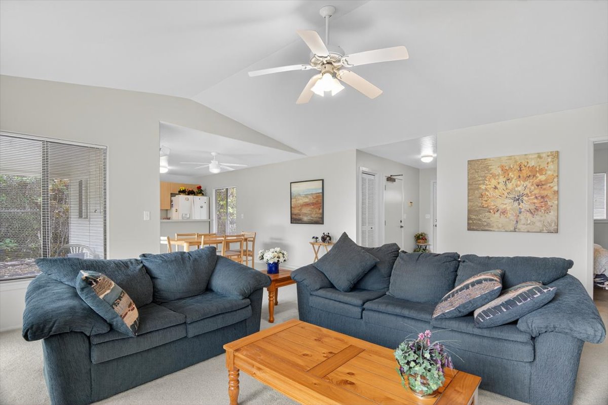 a living room with furniture and a large mirror