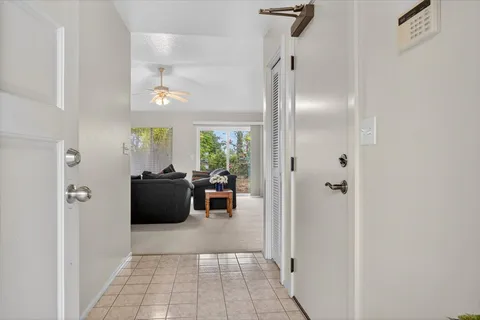 a view of a workspace with furniture and a window
