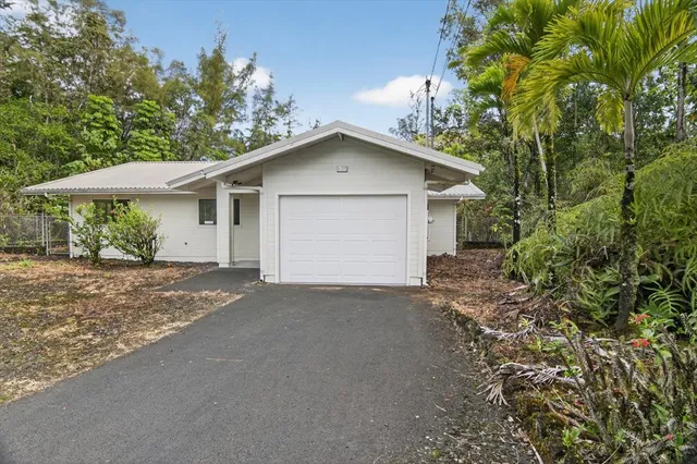 a view of a house with a yard and garage