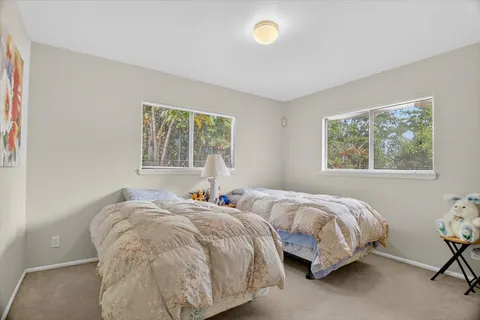 a bedroom with two beds and a window