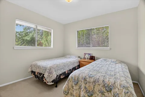 a bedroom with two beds and a window