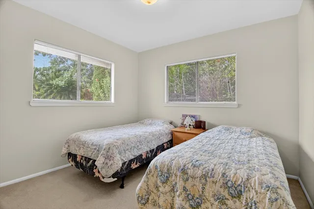 a bedroom with two beds and a window