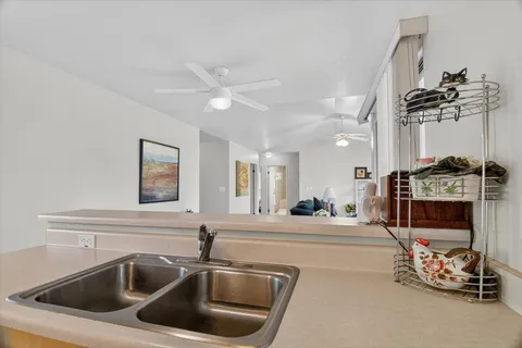 a kitchen with a sink and a stove top oven