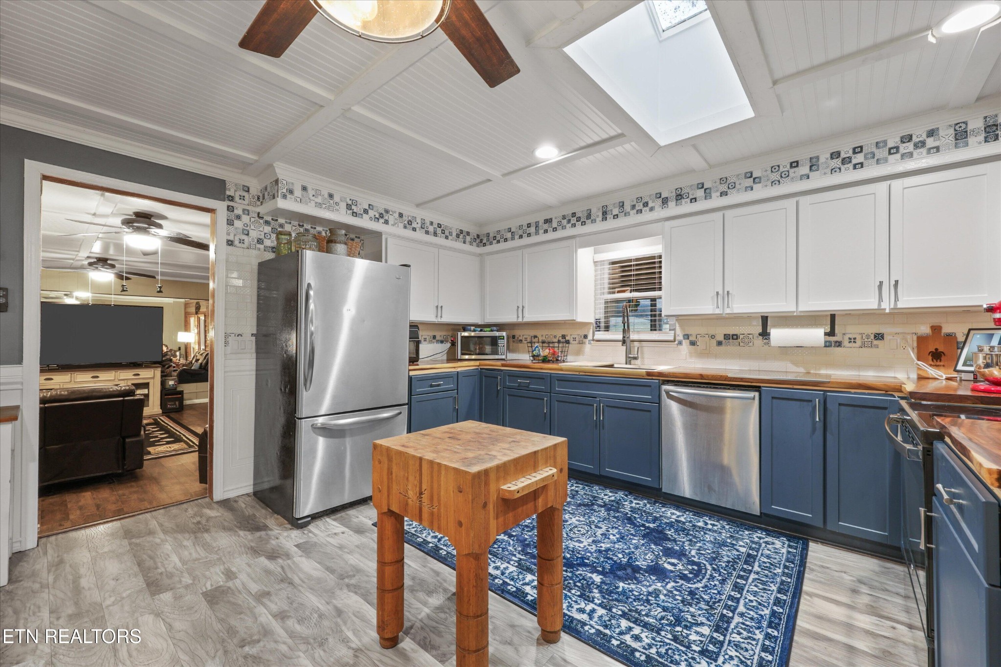 222 Mealer Road Lenoir City, TN 37771 - Photo 12 of 29 a kitchen with stainless steel appliances granite countertop a refrigerator a stove and a sink with wooden floor