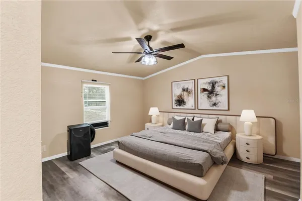 a bedroom with a bed and a chandelier