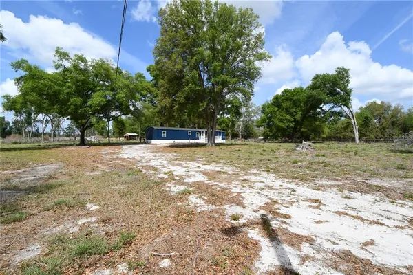 a backyard of a house with lots of green space