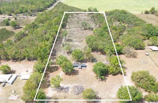 a aerial view of a house with a yard