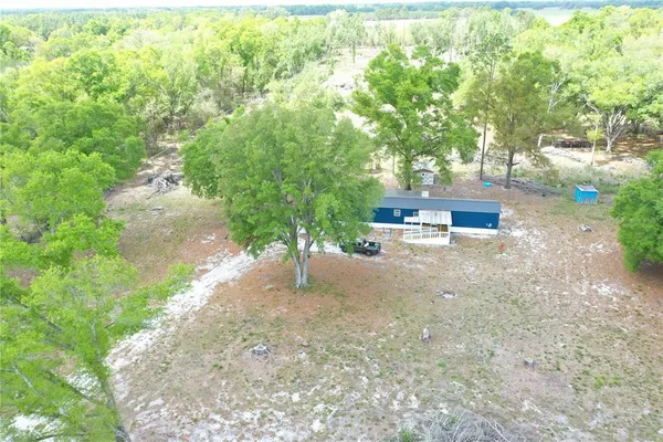 an aerial view of a house with a yard and garden