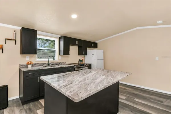 a kitchen with sink stove and microwave