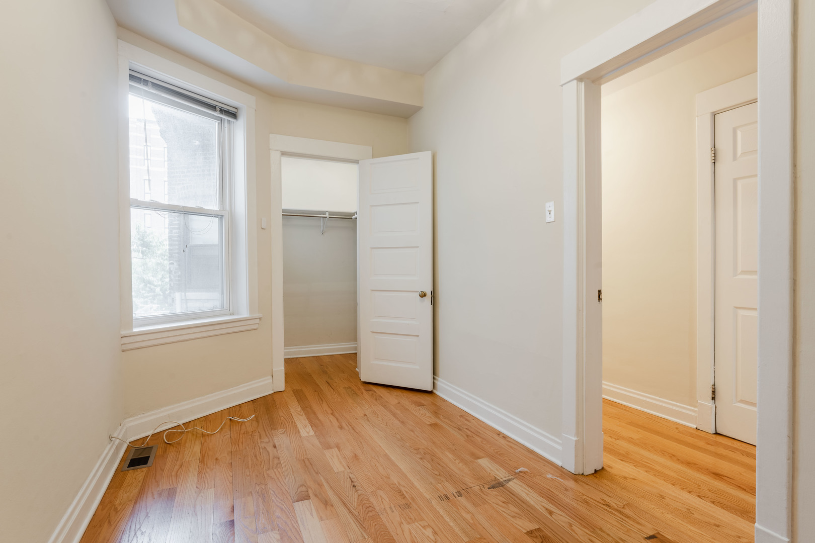 Undisclosed Address Chicago, IL 60614 - Photo 12 of 27 an empty room with wooden floor and windows