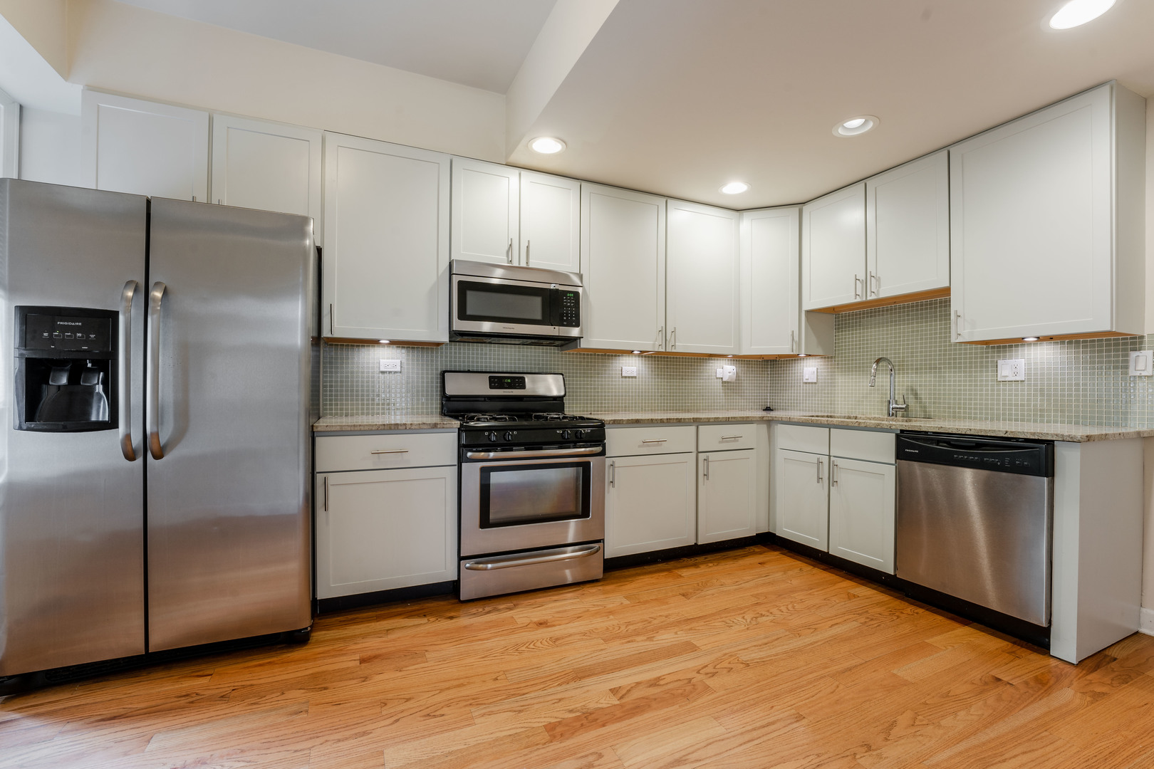 Undisclosed Address Chicago, IL 60614 - Photo 18 of 27 a kitchen with stainless steel appliances and wooden cabinets