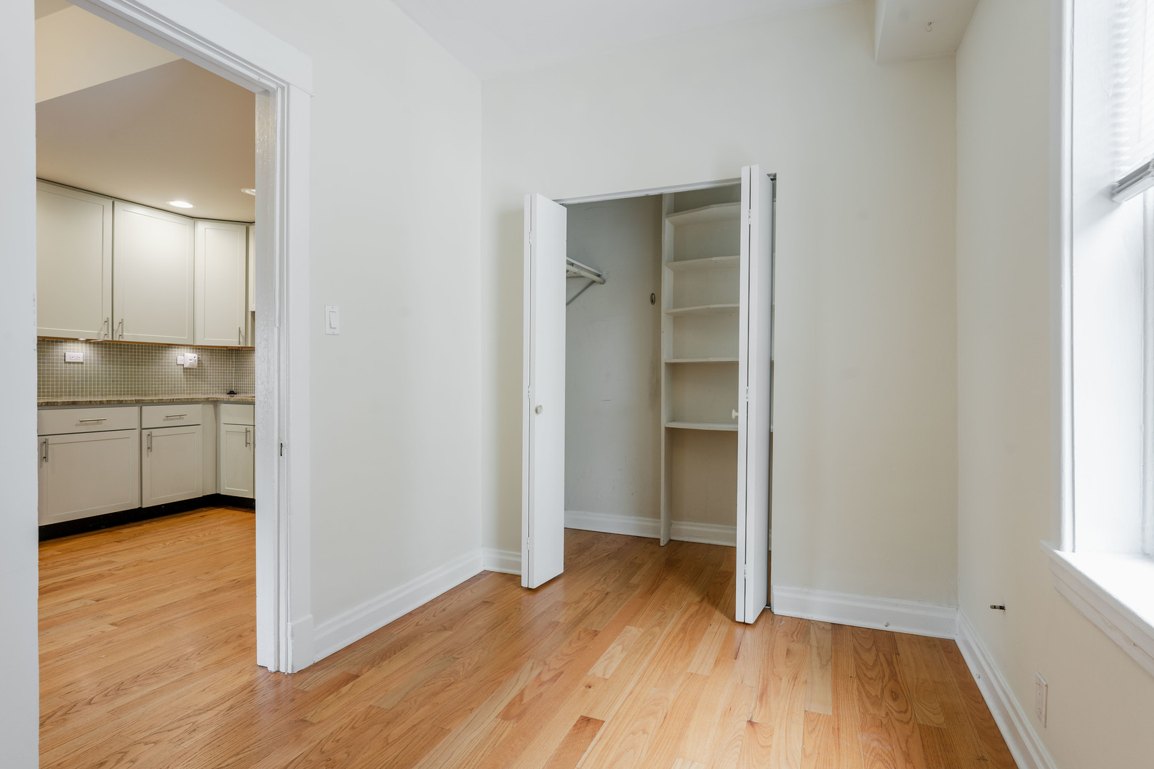 Undisclosed Address Chicago, IL 60614 - Photo 19 of 27 a view of an empty room with wooden floor and a window
