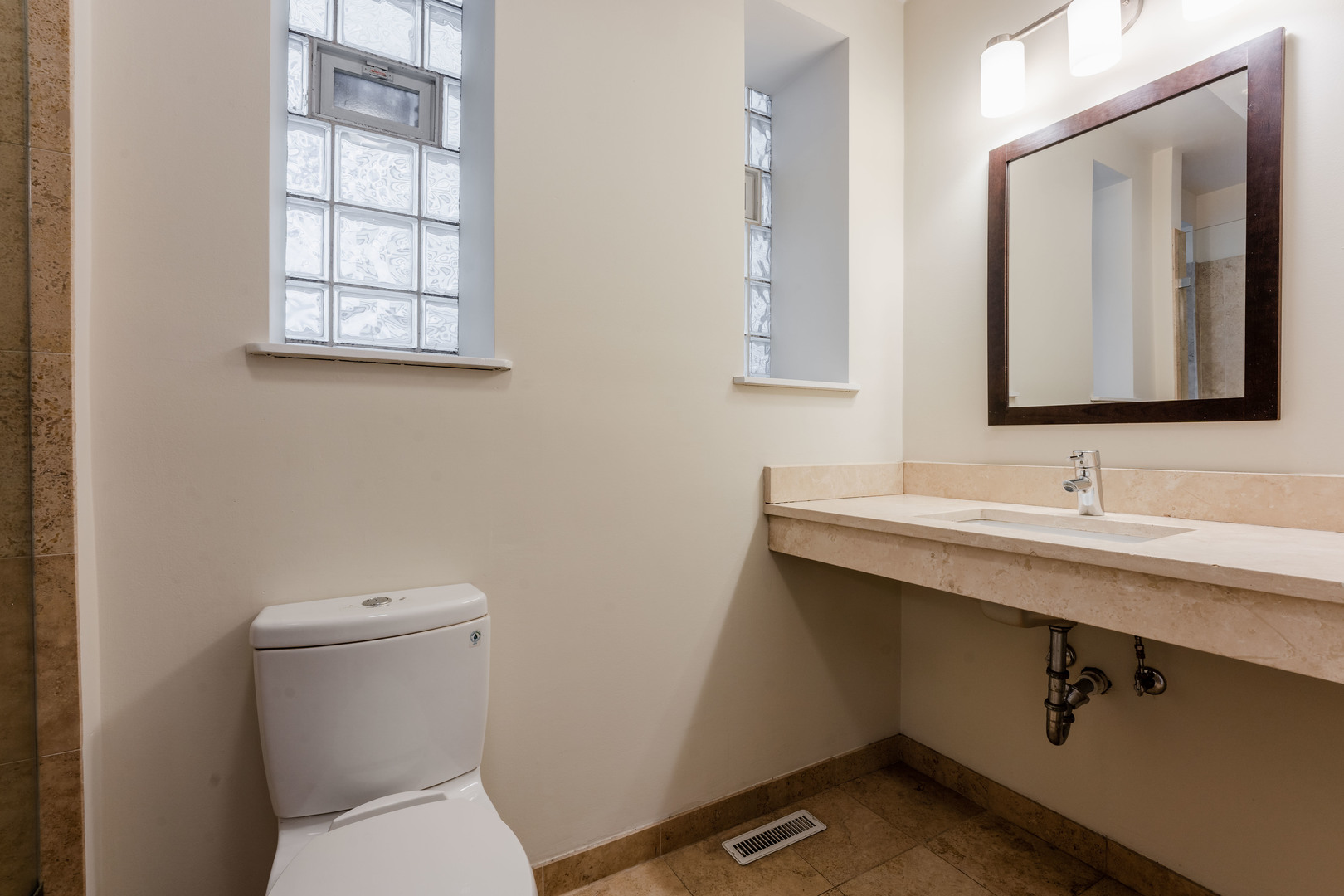Undisclosed Address Chicago, IL 60614 - Photo 5 of 27 a bathroom with a toilet sink and mirror