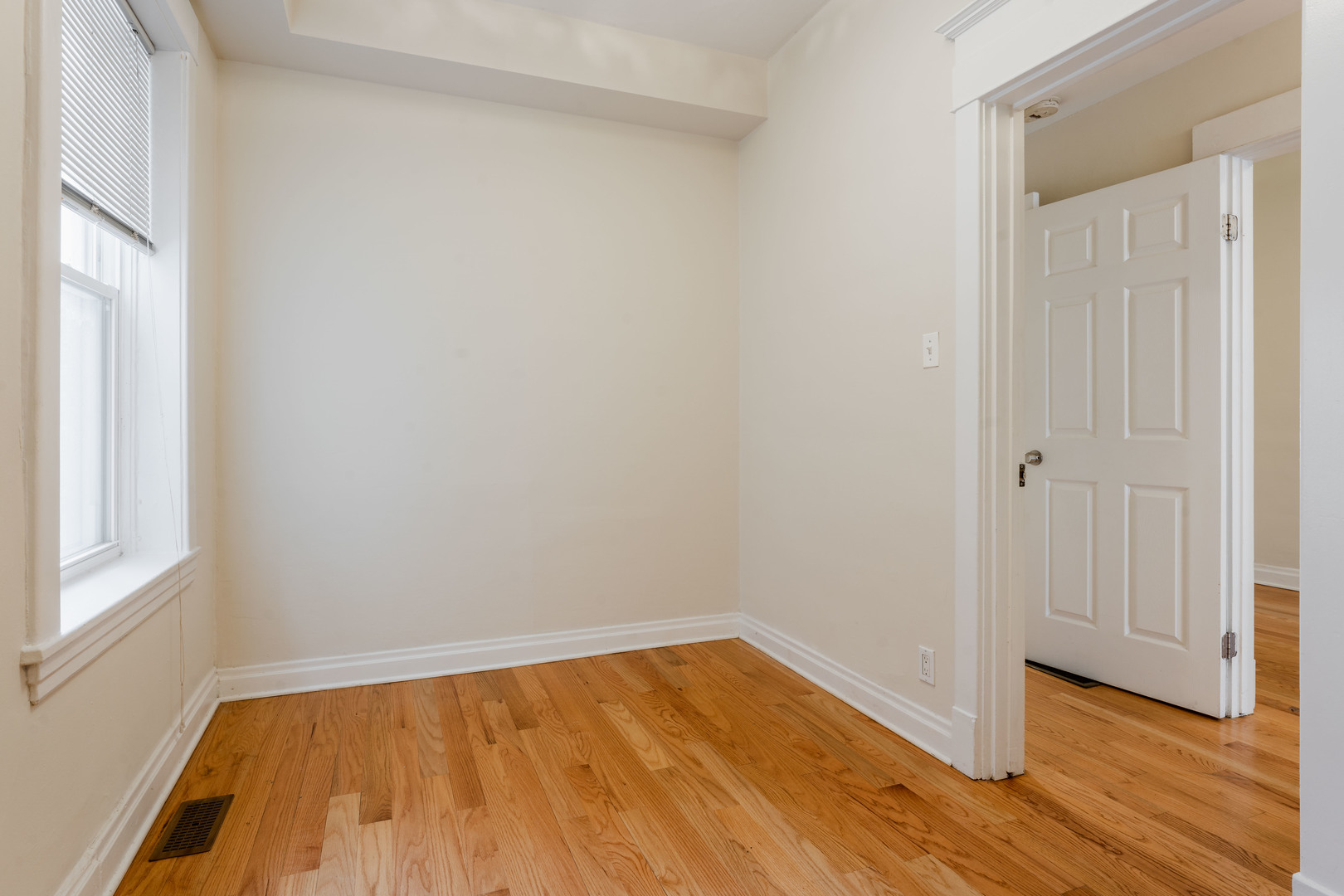 Undisclosed Address Chicago, IL 60614 - Photo 9 of 27 a view of an empty room with wooden floor and a window