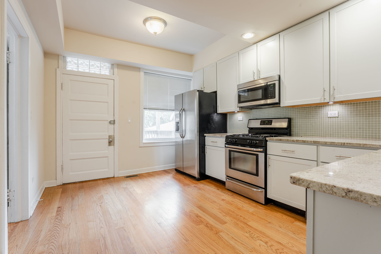 Undisclosed Address Chicago, IL 60614 - Photo 10 of 27 a kitchen with a refrigerator stove and white cabinets