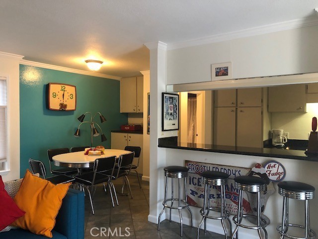 711 Pacific Coast Highway, Unit 303 Huntington Beach, CA 92648 - Photo 12 of 22 a view of a dining room with furniture and a potted plant
