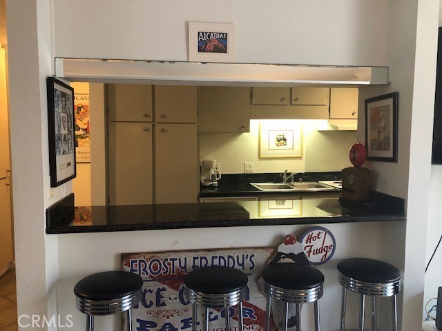 711 Pacific Coast Highway, Unit 303 Huntington Beach, CA 92648 - Photo 13 of 22 a kitchen with a stove and a table