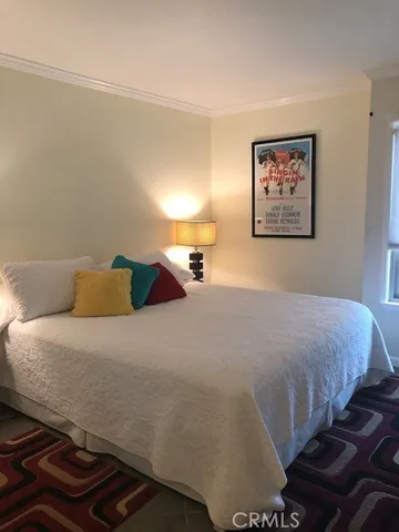 a bedroom with a bed and lamp