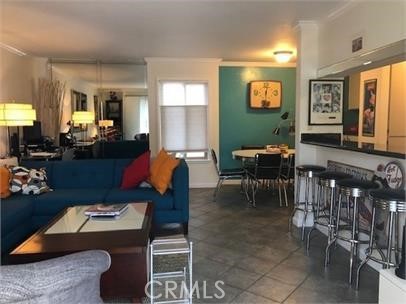 711 Pacific Coast Highway, Unit 303 Huntington Beach, CA 92648 - Photo 5 of 22 a living room with furniture a dining table and large window