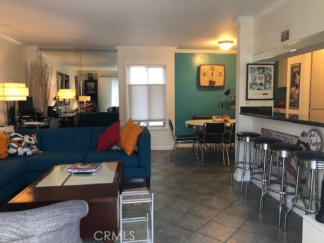 711 Pacific Coast Highway, Unit 303 Huntington Beach, CA 92648 - Photo 8 of 22 a living room with furniture a dining table and large window