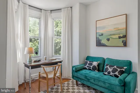 a view of a bedroom with furniture and wooden floor