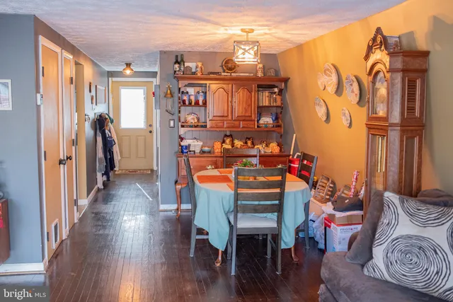 a dining room with furniture and wooden floor