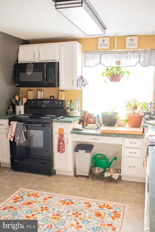 a kitchen with stainless steel appliances granite countertop a sink and a stove