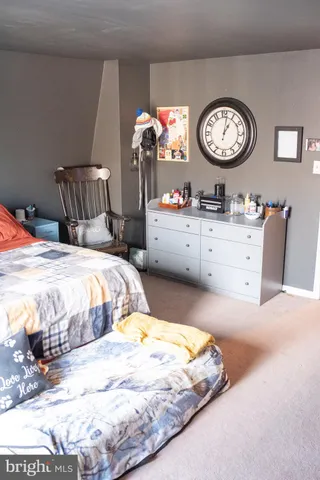a bed sitting in a bedroom and mirror