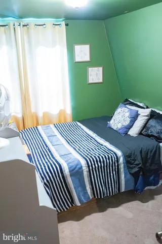 a living room with furniture a rug and a floor to ceiling window