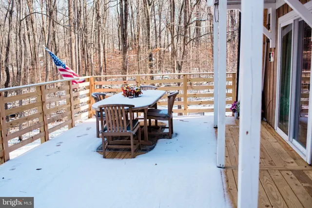 a view of a chairs and table in the balcony