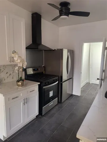 a kitchen with stainless steel appliances granite countertop a sink and a stove