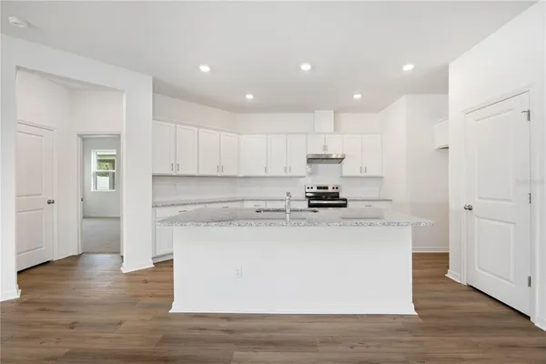 a kitchen with a sink stainless steel appliances and cabinets