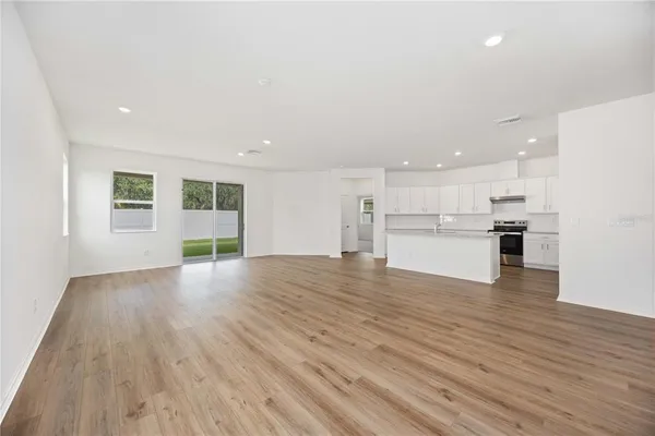 a view of kitchen with wooden floor and windows