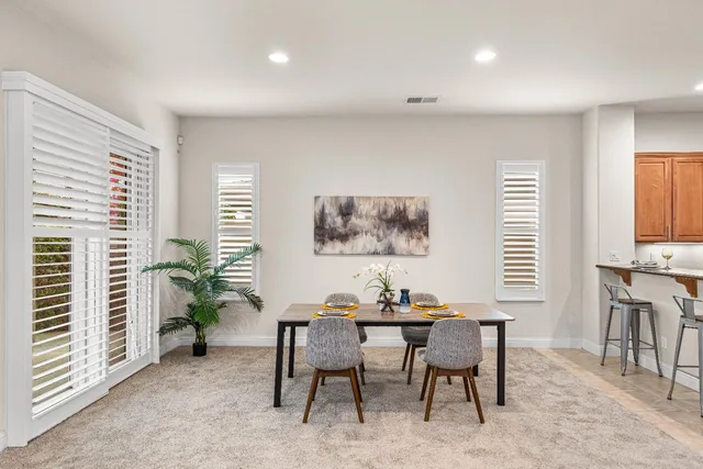 a kitchen with granite countertop white cabinets and stainless steel appliances