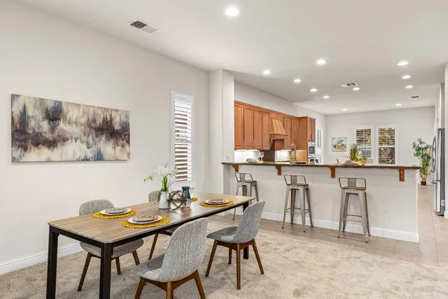 a view of a dining room with furniture and window