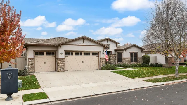 a front view of a house with a garden