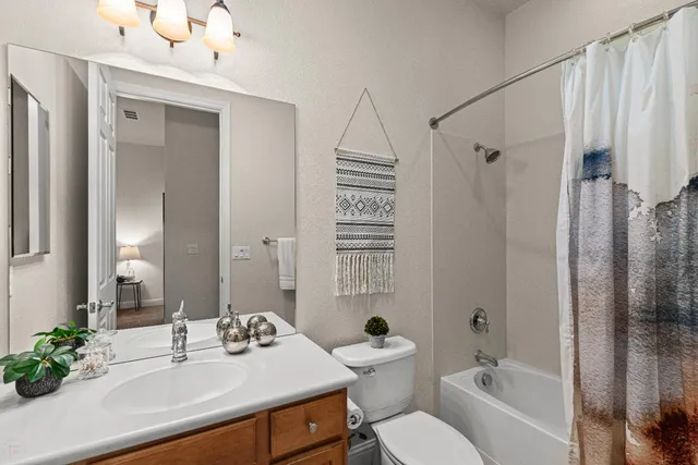 an aerial view of residential houses with outdoor space and trees