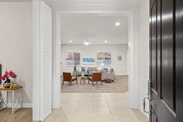 a living room with furniture a fireplace and a piano