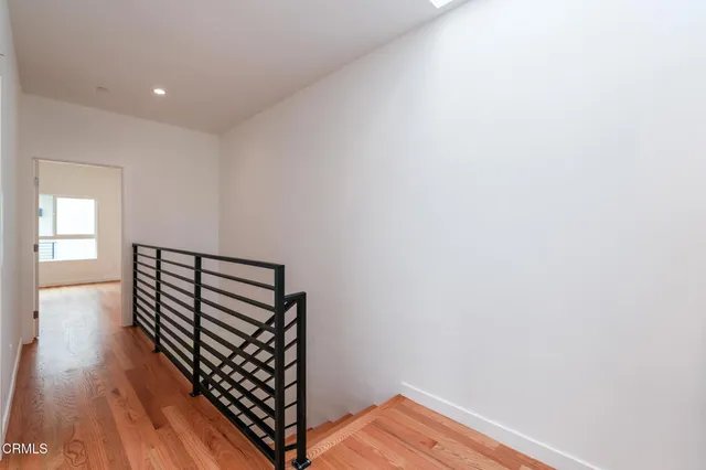 a view of a room with wooden floor